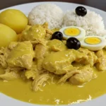 Best homemade Aji de Gallina recipe with creamy aji amarillo sauce, served over potatoes with rice, boiled eggs, and olives.
