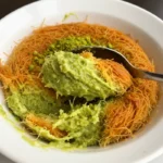 Creamy pistachio mixture with toasted kataifi strands in a white bowl